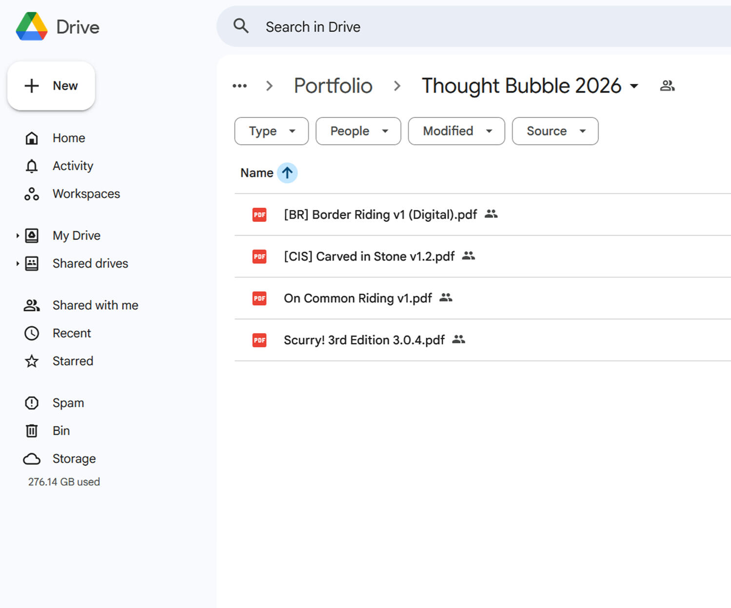 A photo of Brian Tyrrell. He has short black hair, an upper lip moustache, and stubble. He is holding a white labrador in his arms.